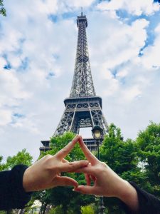 throwing handsign in front of eiffel tower