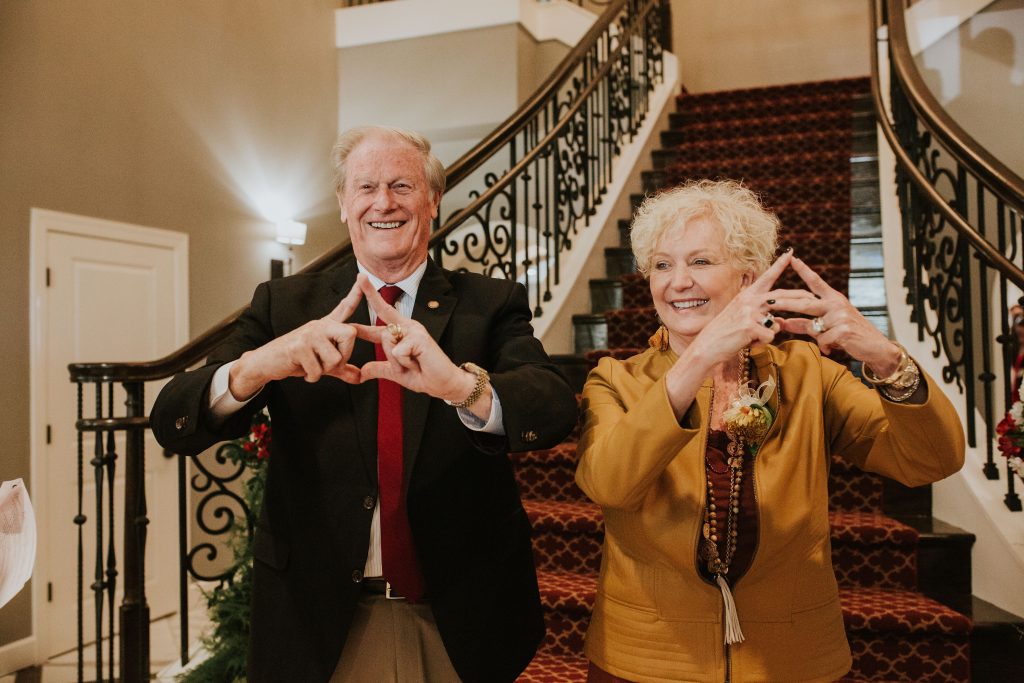 Florida State University President and his wife throwing the handsign