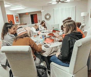 Alpha Gams at Western Missouri make cards for Meals on Wheels