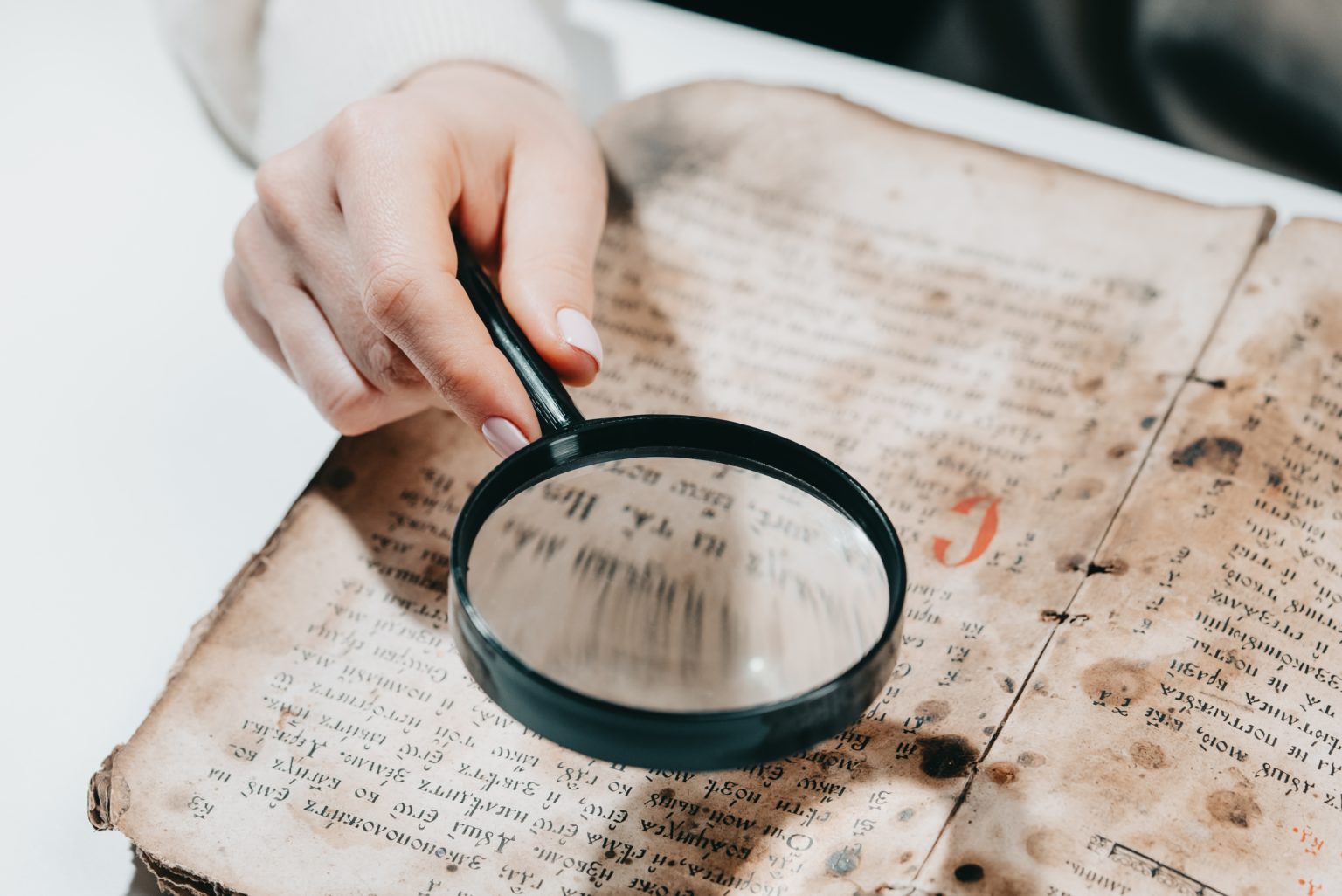 historian-scientist-reading-antique-book-with-magnifying-glass