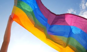 A rainbow pride flag waving in the air.